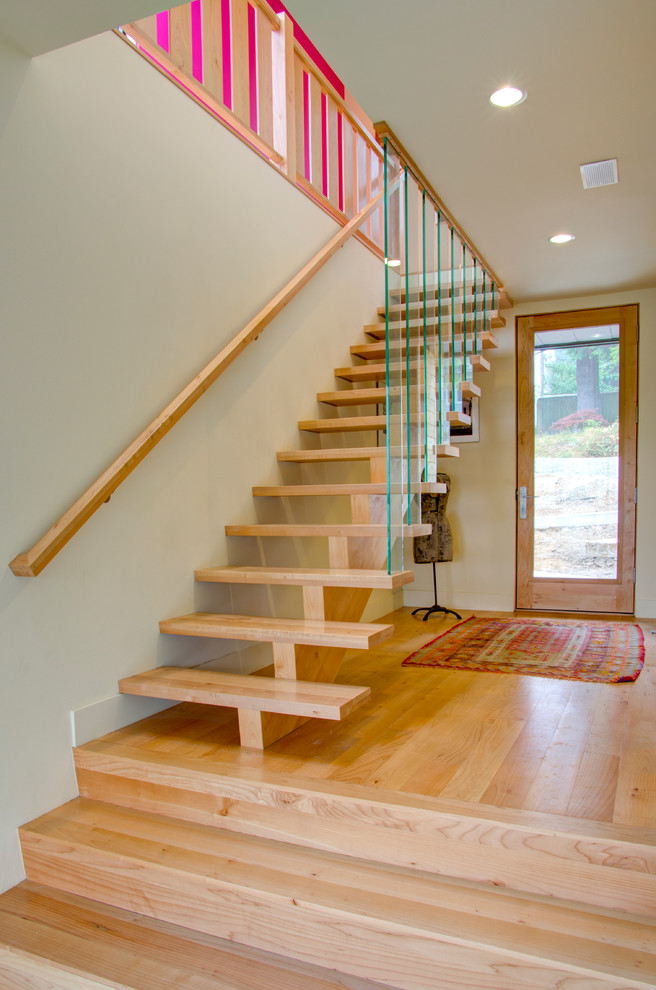 Photo of a contemporary wood staircase in Portland with open risers.