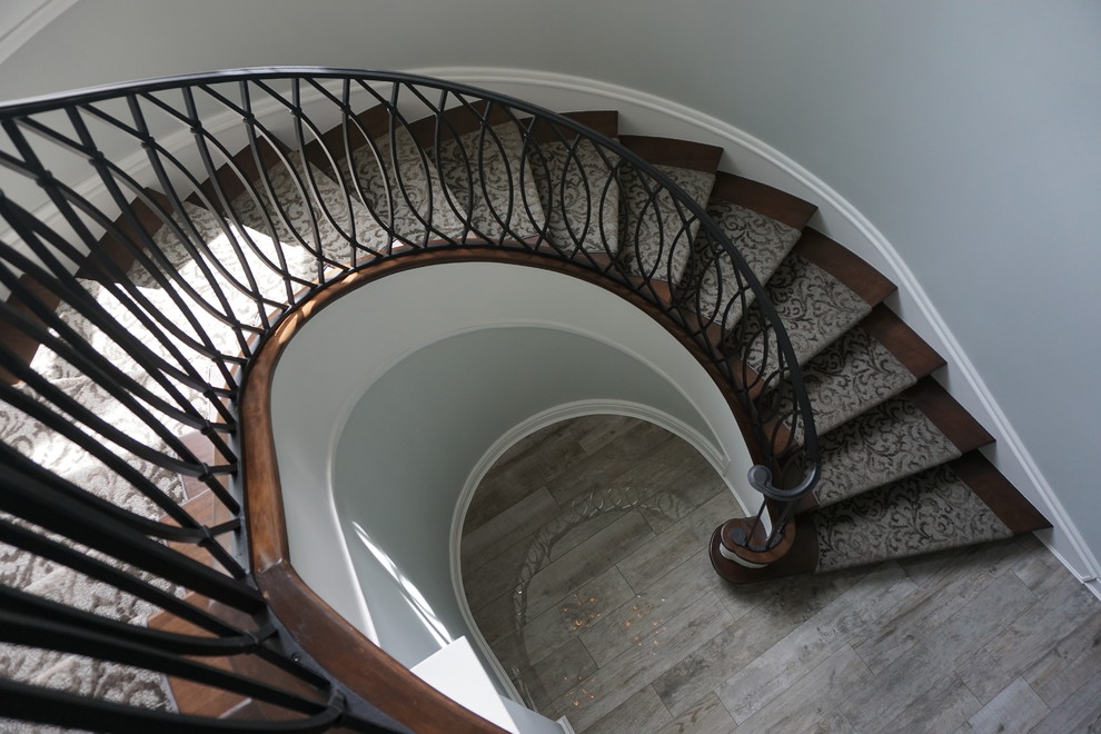 Large retro carpeted spiral staircase in Columbus with metal risers.