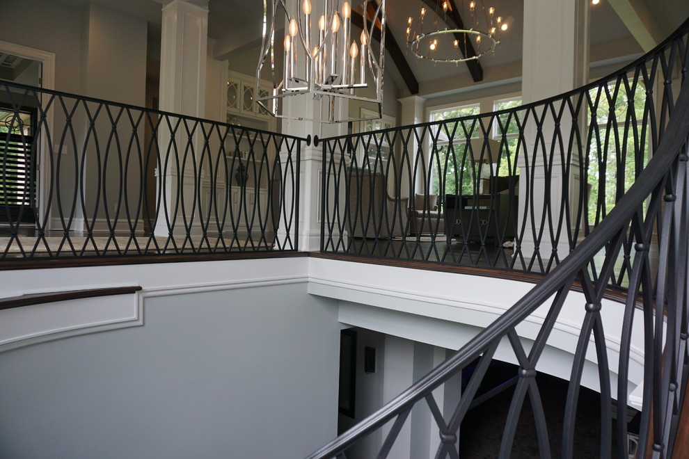 Inspiration for a large retro carpeted spiral staircase in Columbus with metal risers.