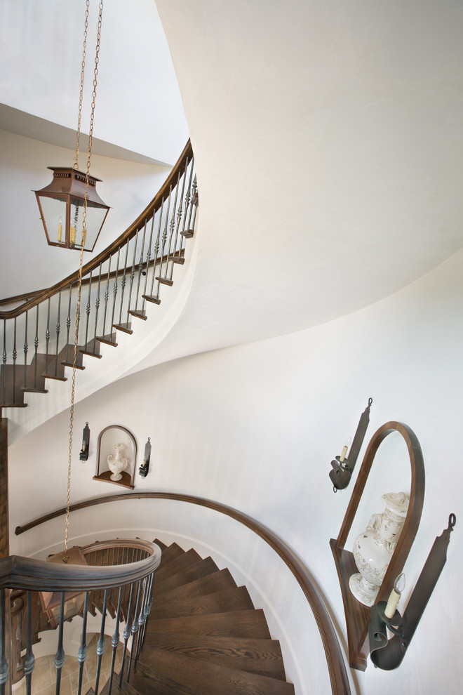 Inspiration for a large mediterranean wood spiral staircase in Other with wood risers.