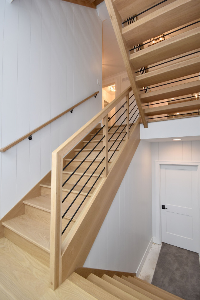 Example of a cottage wooden u-shaped wood railing staircase design in Chicago with wooden risers