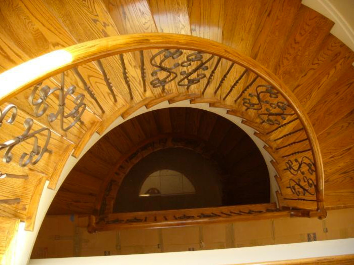 Exemple d'un grand escalier hélicoïdal avec des marches en bois et des contremarches en bois.