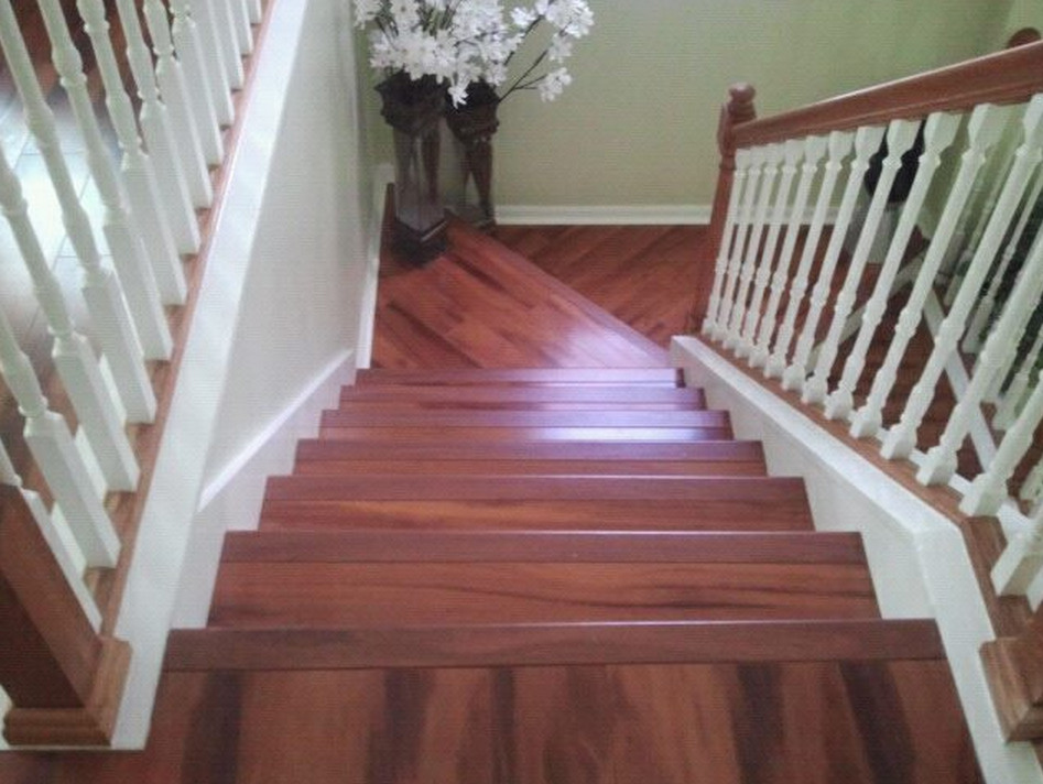Large wooden u-shaped staircase photo in Tampa with wooden risers