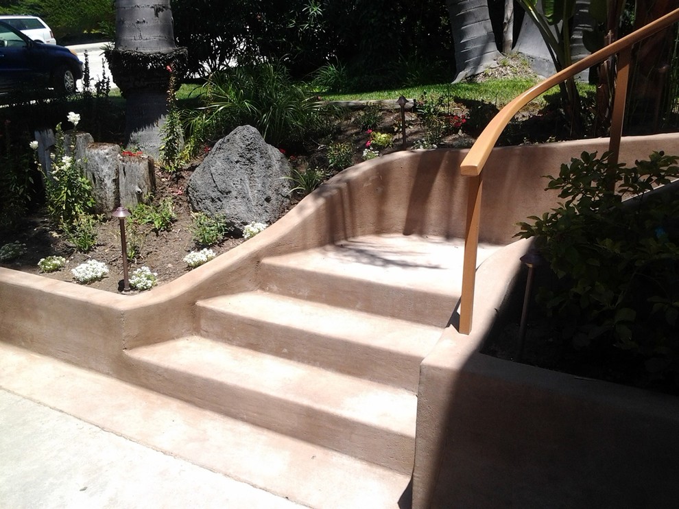 This is an example of a small concrete curved staircase in San Diego with concrete risers.