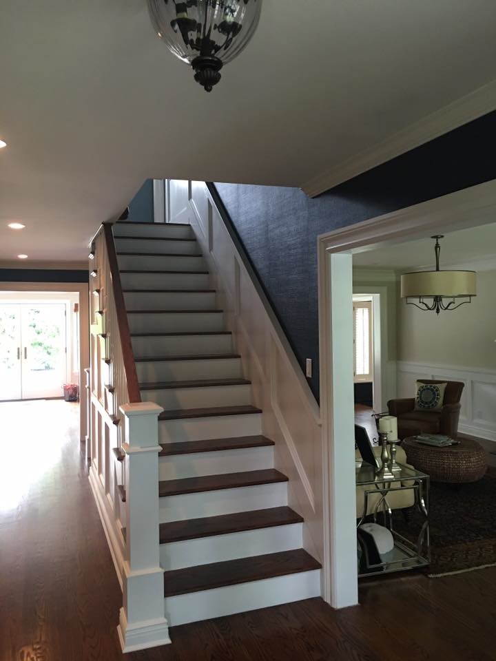 Medium sized traditional wood straight staircase in New York with painted wood risers.