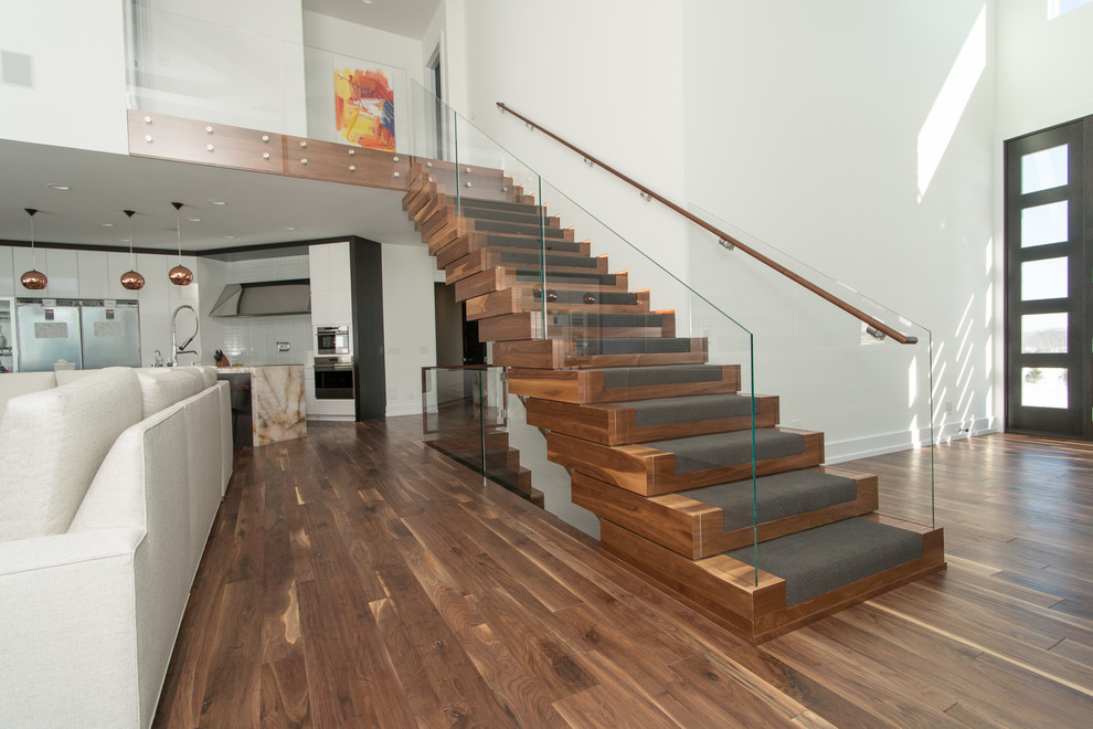 Inspiration for a large modern wooden floating staircase remodel in Cleveland with wooden risers