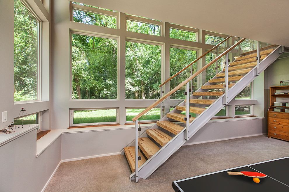 Photo of a medium sized contemporary wood straight staircase in Detroit with open risers.