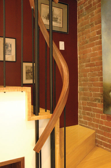 ボストンにある小さなコンテンポラリースタイルのおしゃれなサーキュラー階段 (木の蹴込み板、木材の手すり) の写真