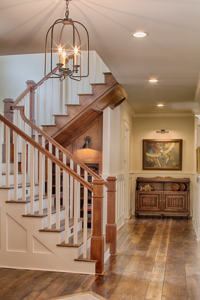 Inspiration for a large traditional wood u-shaped staircase in Grand Rapids with painted wood risers.