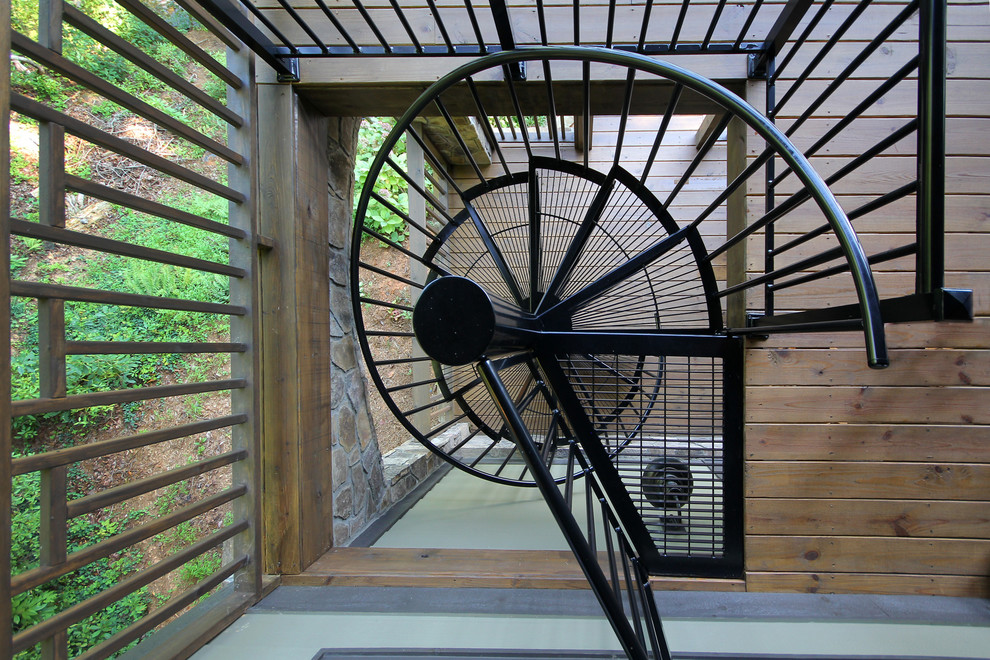 Large mountain style metal spiral staircase photo in Atlanta with metal risers