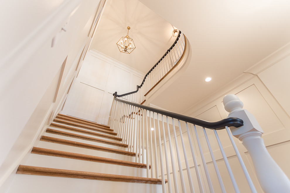 Photo of a medium sized classic wood l-shaped wood railing staircase in Atlanta with painted wood risers.