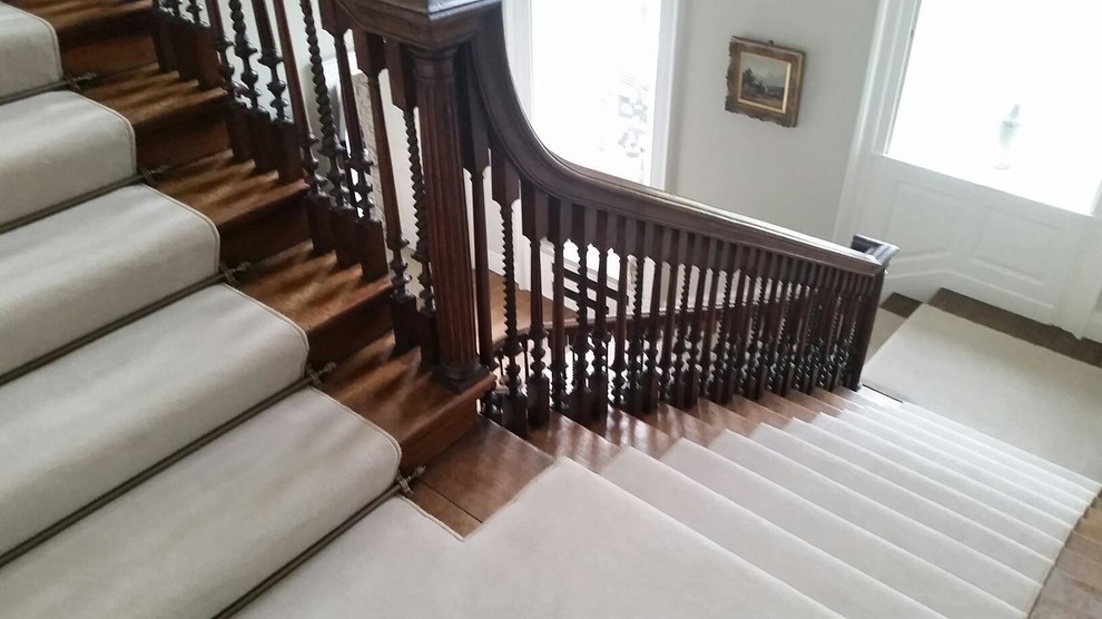Example of a large classic carpeted u-shaped staircase design in Surrey with carpeted risers