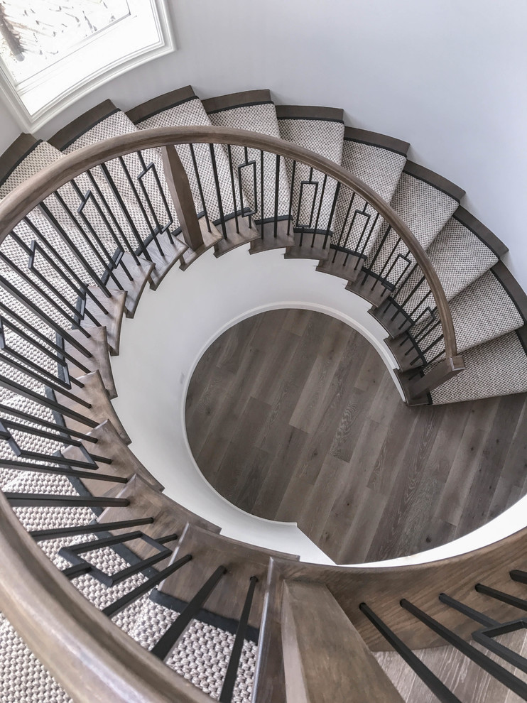 Inspiration for a large contemporary wooden curved mixed material railing staircase remodel in San Diego with wooden risers