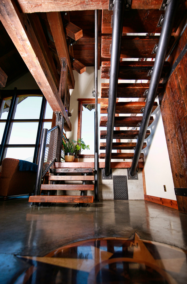 Medium sized urban wood u-shaped metal railing staircase in Other with open risers.