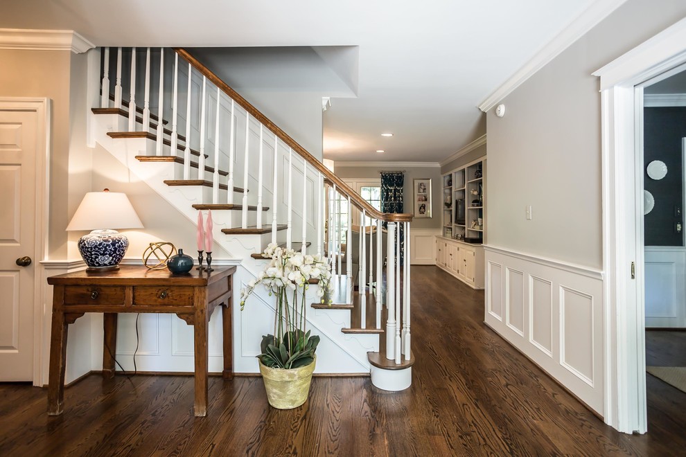 Large elegant wooden straight wood railing staircase photo in Philadelphia with painted risers