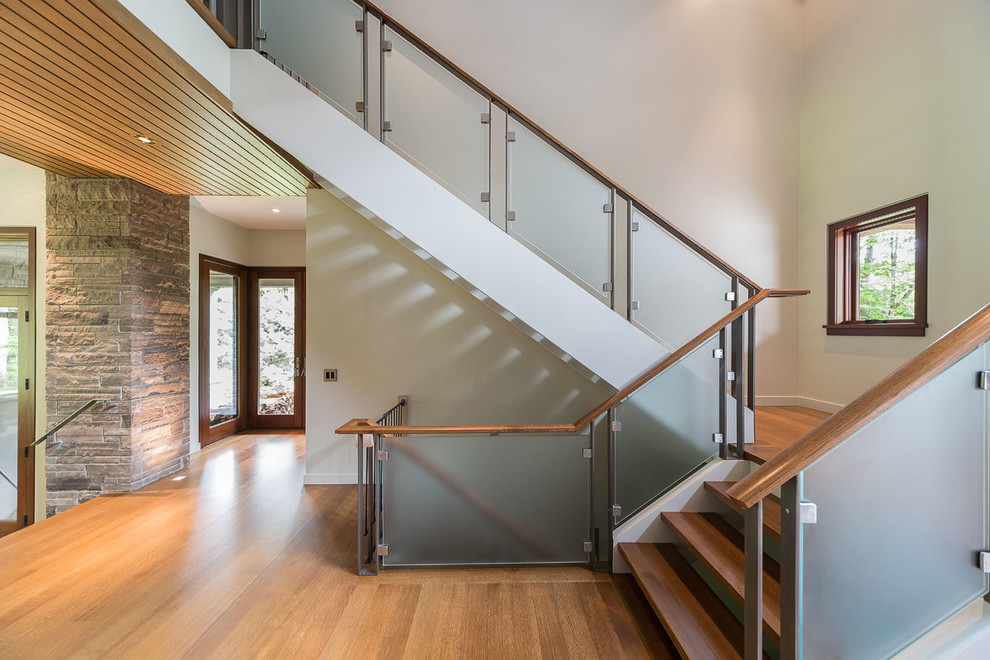This is an example of a contemporary wood l-shaped staircase in Toronto with open risers.