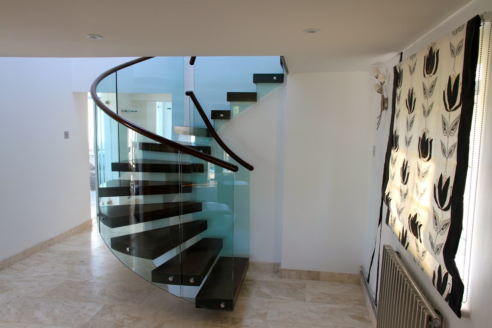 Design ideas for a medium sized contemporary wood spiral staircase in Other with open risers.