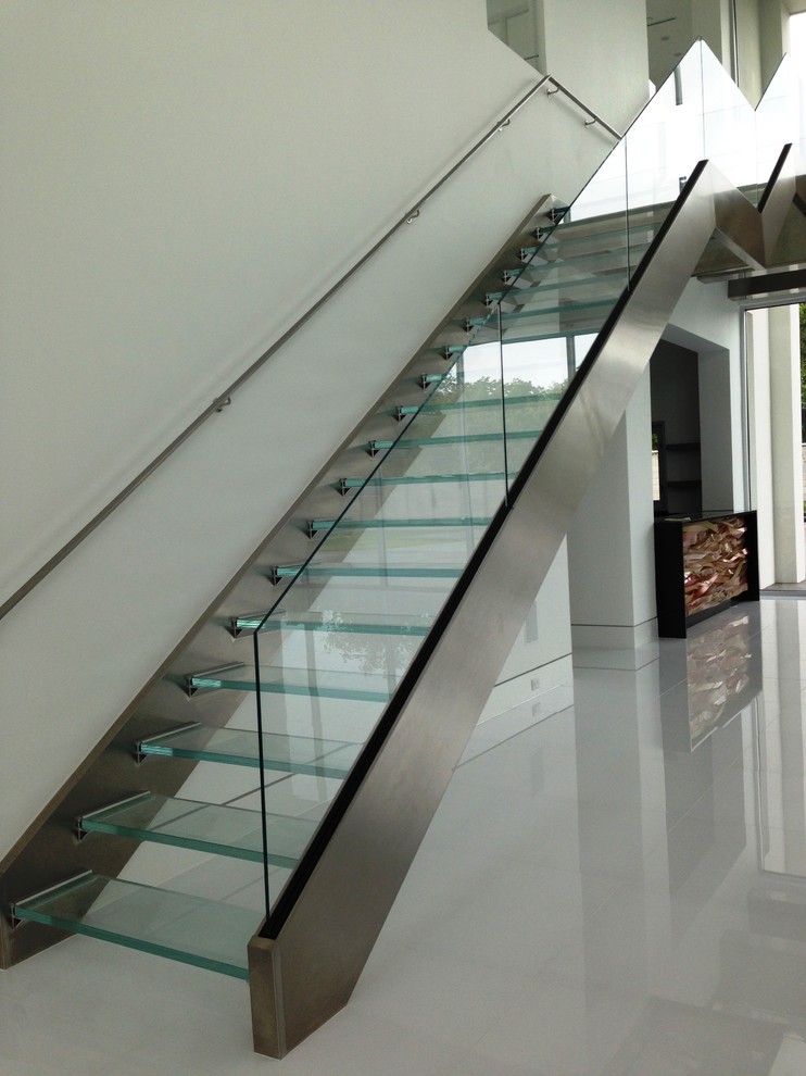 This is an example of a medium sized contemporary glass straight staircase in Cleveland with open risers.