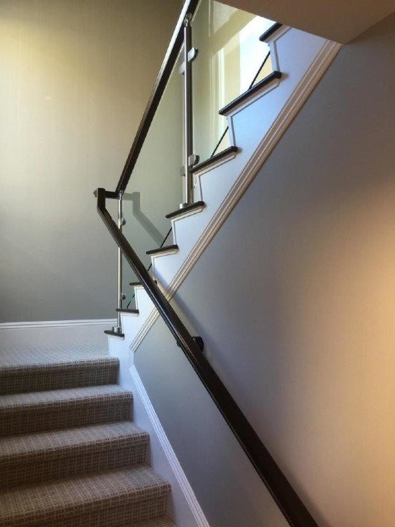 Inspiration for a contemporary wood l-shaped wood railing staircase in Orange County with painted wood risers.