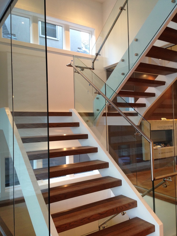Photo of a medium sized modern wood staircase in Calgary.