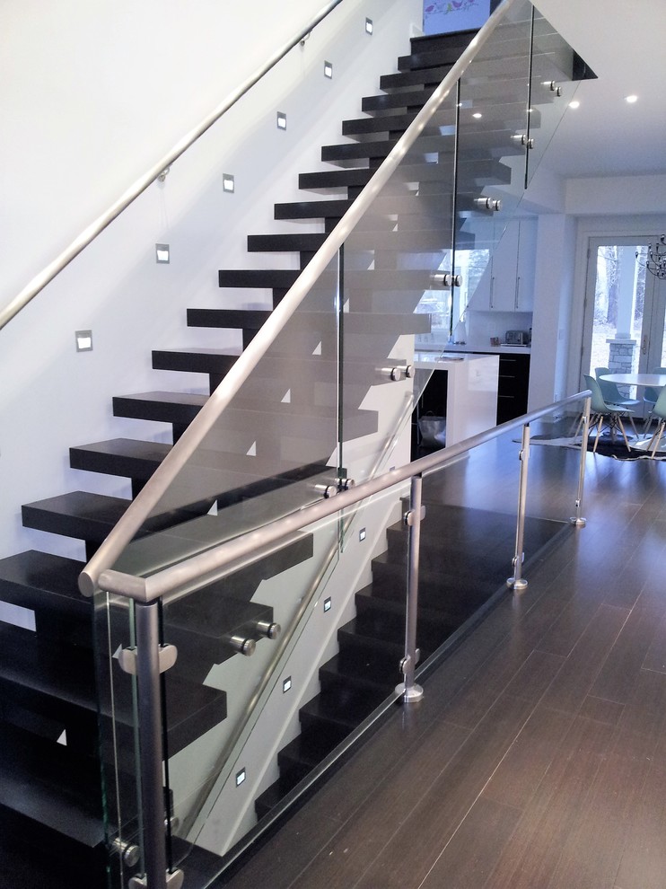 Источник вдохновения для домашнего уюта: большая лестница на больцах в стиле модернизм с крашенными деревянными ступенями и стеклянными перилами