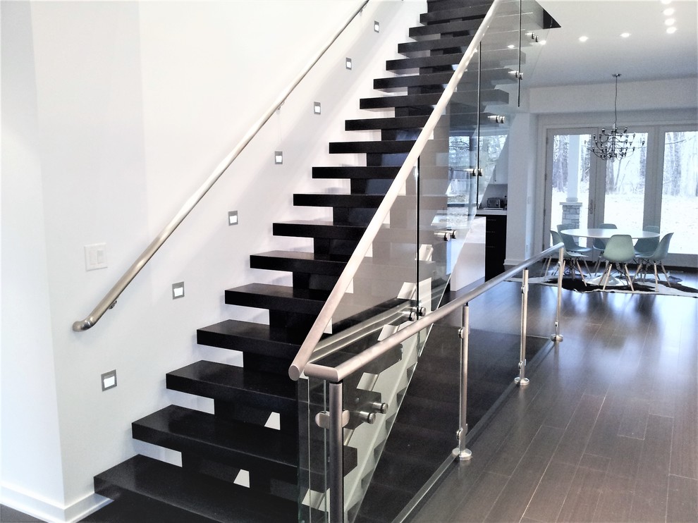 Design ideas for a large modern painted wood floating glass railing staircase in Indianapolis.