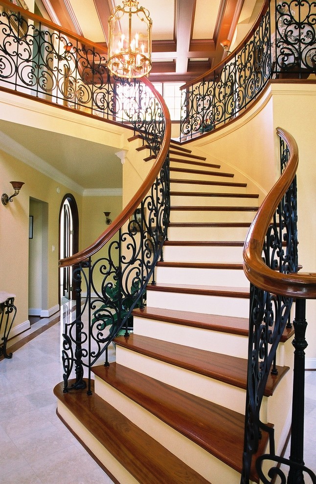 Staircase - large traditional wooden curved staircase idea in Richmond with painted risers