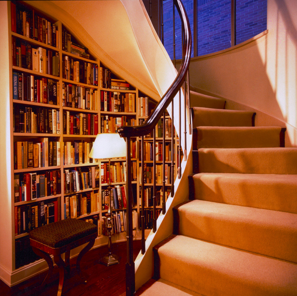 Contemporary spiral staircase in New York with under stair storage and feature lighting.
