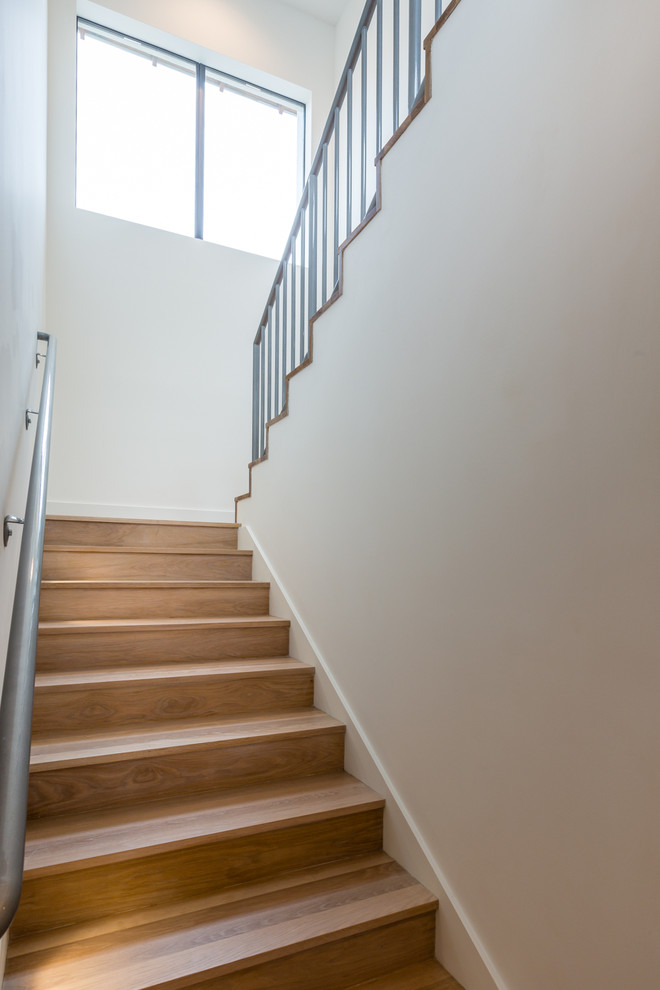 На фото: п-образная деревянная лестница среднего размера в стиле модернизм с деревянными ступенями