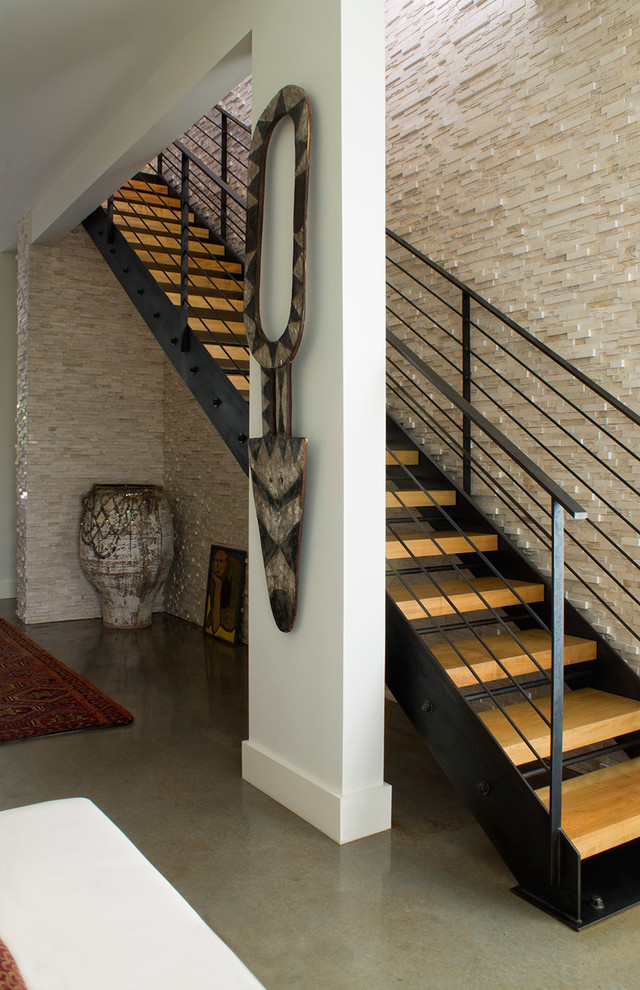 Photo of a world-inspired wood straight wire cable railing staircase in Orlando with open risers.