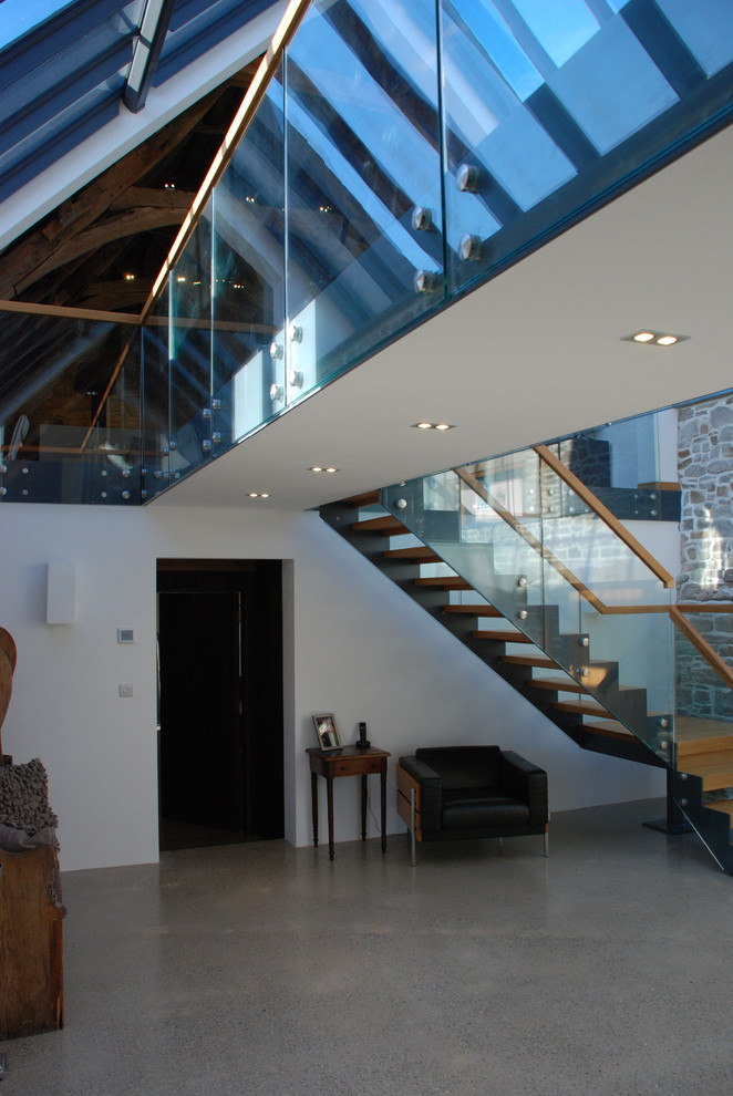 Inspiration for an expansive contemporary wood l-shaped wood railing staircase in Cornwall with open risers.
