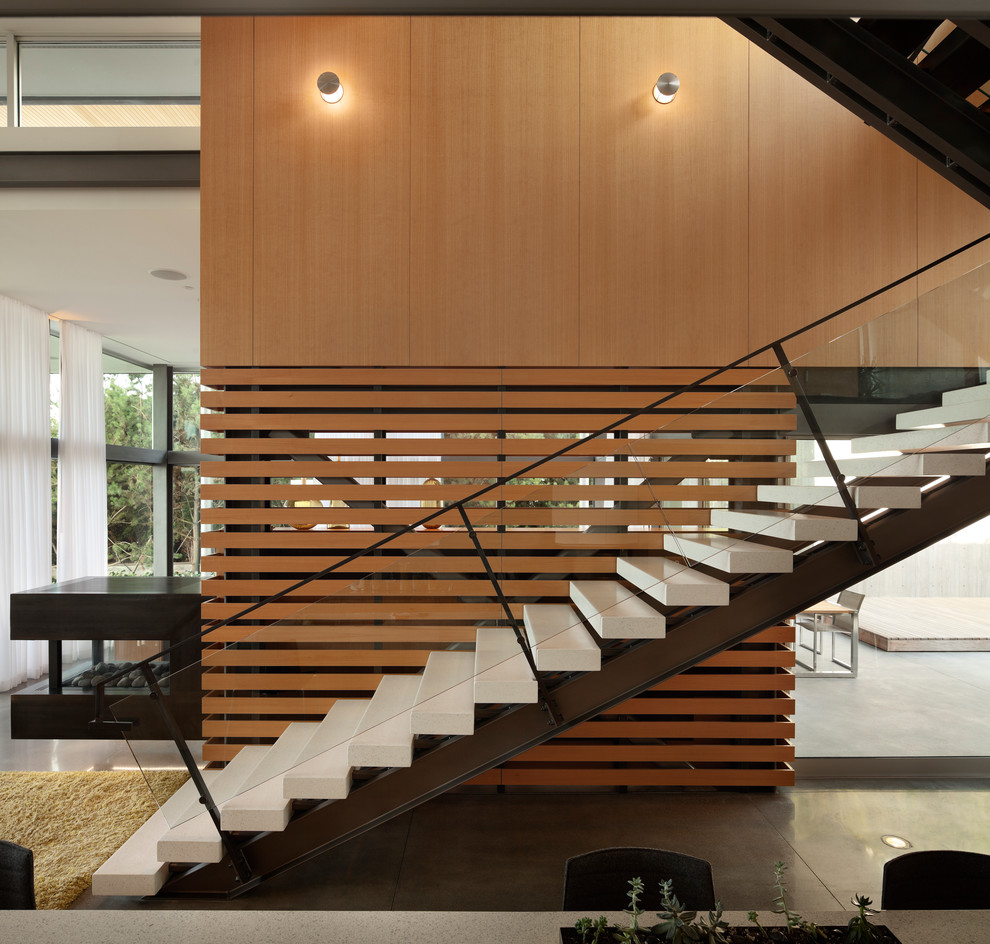 Idée de décoration pour un escalier sans contremarche droit minimaliste en béton.