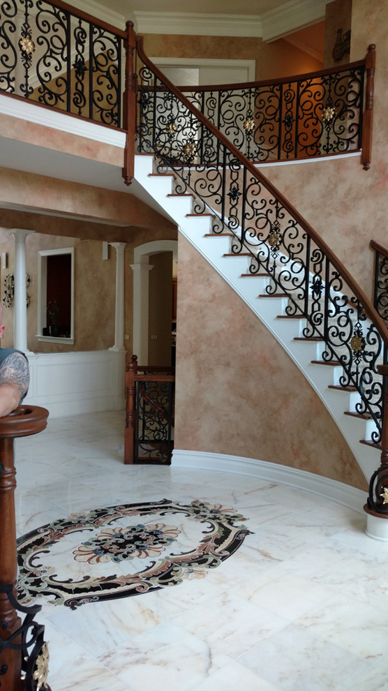 Example of a large tuscan carpeted curved staircase design in New York with carpeted risers