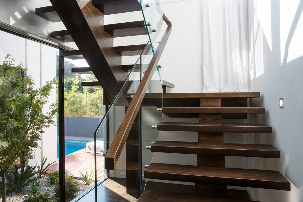 Design ideas for a large modern u-shaped glass railing staircase in Melbourne.