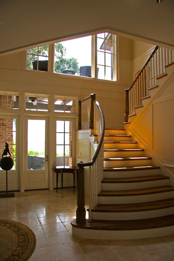 Medium sized classic wood l-shaped wood railing staircase in Other with painted wood risers and feature lighting.