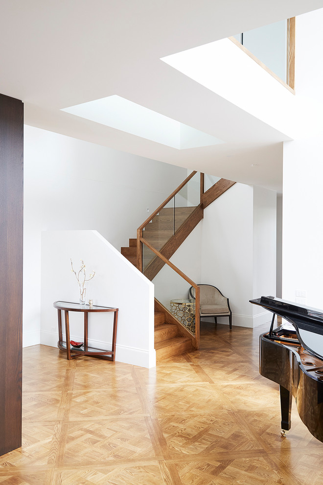 Photo of a large contemporary wood u-shaped wood railing staircase in Melbourne with wood risers.