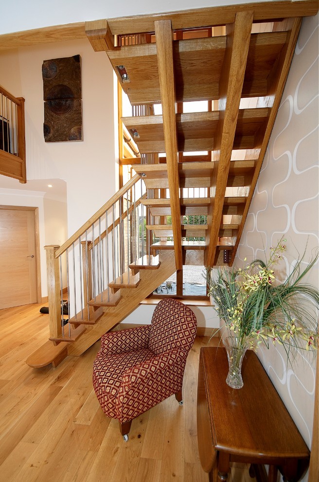 Photo of a medium sized contemporary wood floating staircase in Cambridgeshire with open risers.