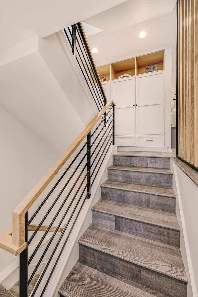 Staircase - small contemporary wooden u-shaped metal railing staircase idea in Seattle with wooden risers