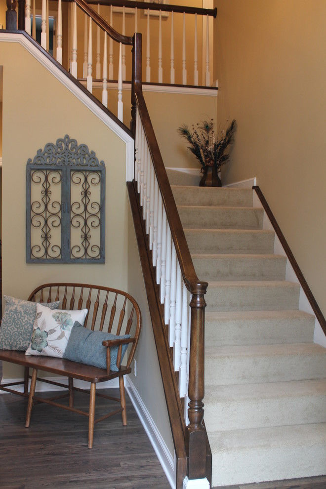Example of a mid-sized classic carpeted curved staircase design in Cleveland with carpeted risers
