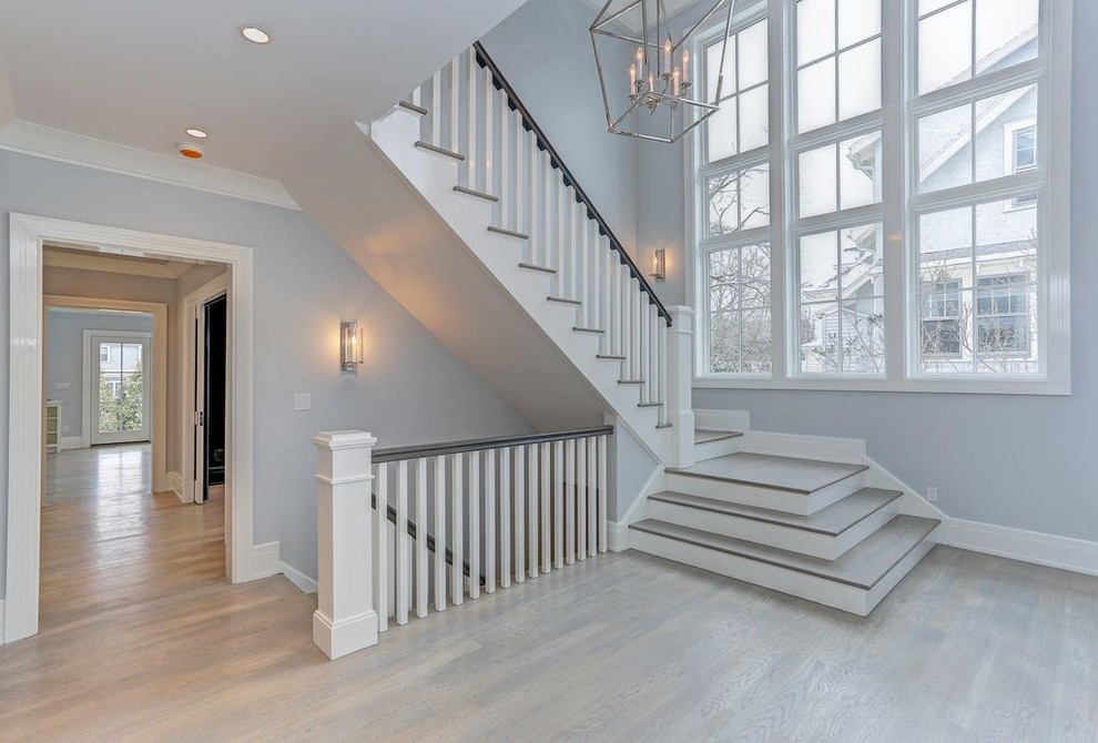 Staircase - large contemporary wooden u-shaped staircase idea in New York with painted risers
