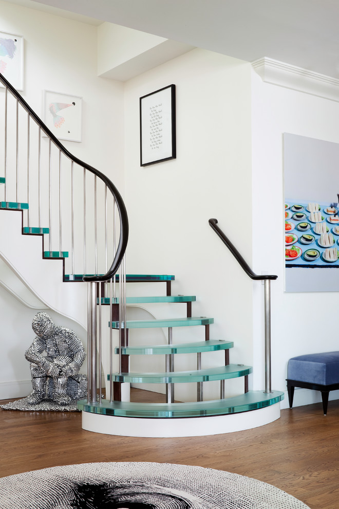 Large contemporary glass curved staircase in New York with open risers.