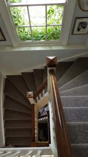 Imagen de escalera en U clásica renovada de tamaño medio con escalones enmoquetados, contrahuellas enmoquetadas y barandilla de madera