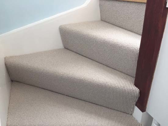 Inspiration for a traditional carpeted u-shaped wood railing staircase in London with carpeted risers.