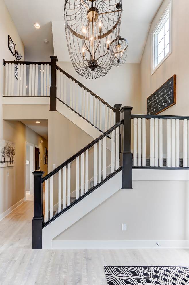Mid-sized transitional carpeted u-shaped wood railing staircase photo in Other with carpeted risers