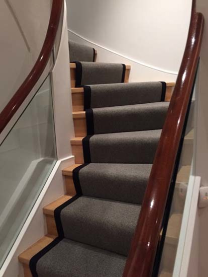 Staircase - mid-sized transitional carpeted u-shaped mixed material railing staircase idea in London with carpeted risers