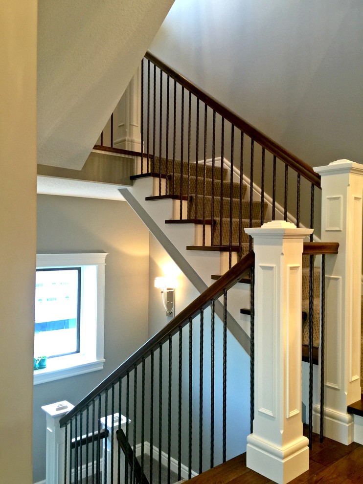 Mid-sized transitional wooden u-shaped staircase photo in Minneapolis with carpeted risers