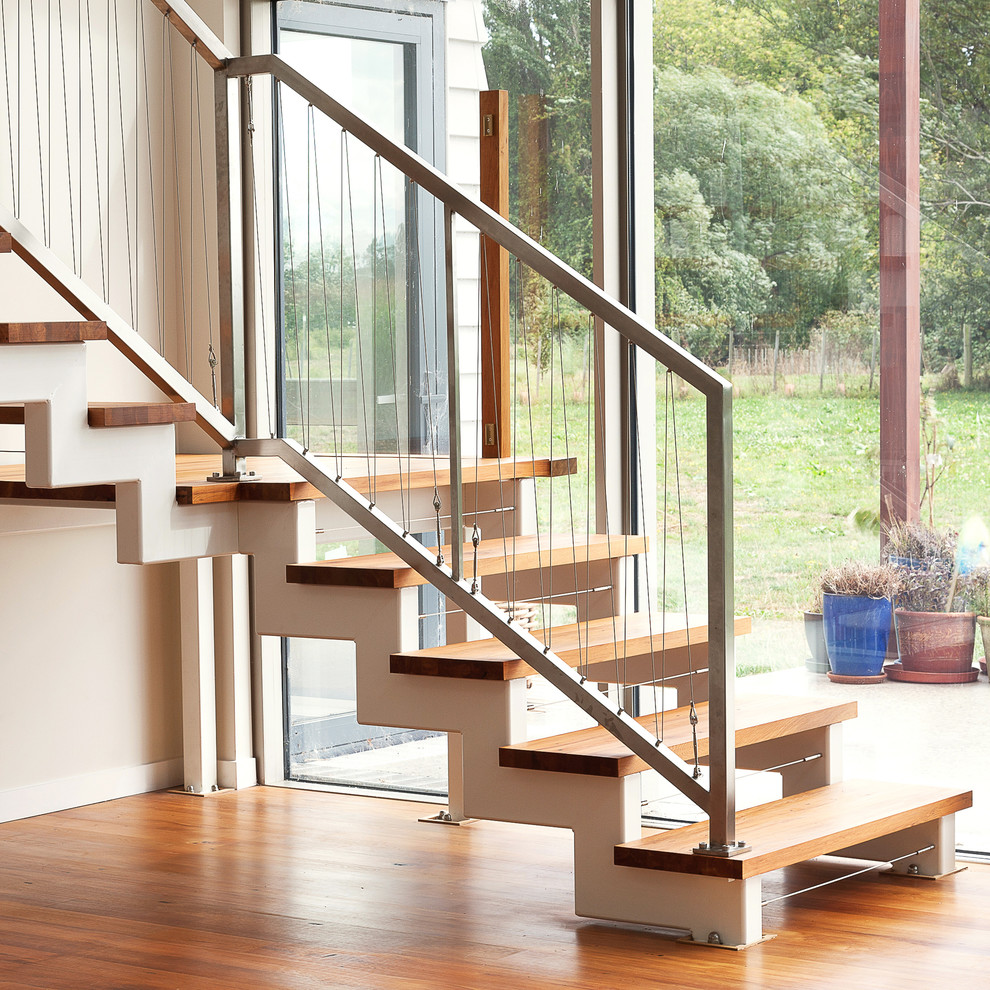 Example of a transitional wooden l-shaped open staircase design in Wellington