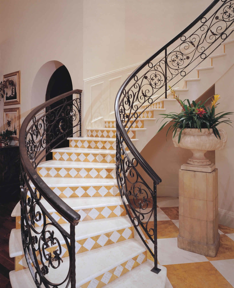 Photo of a large mediterranean curved staircase in Miami with tiled risers.