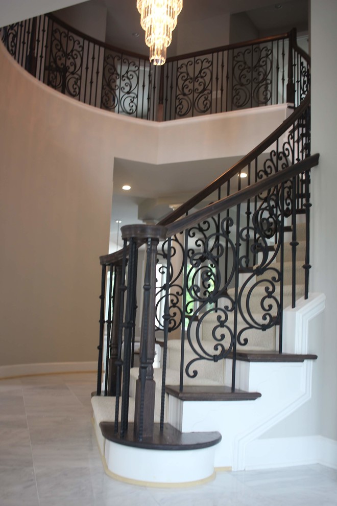 Large traditional curved mixed railing staircase in DC Metro.