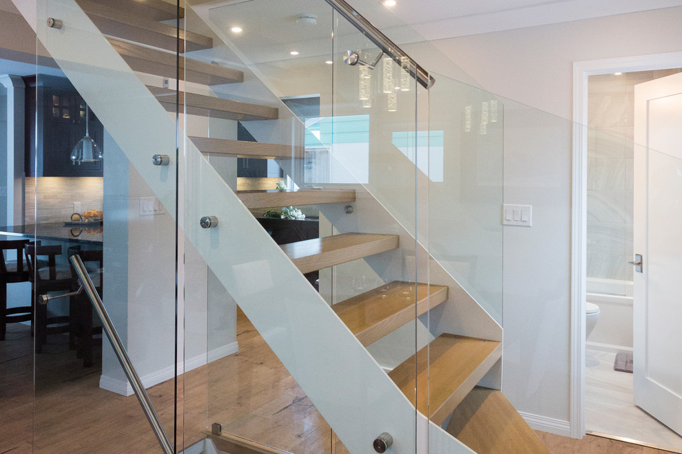This is an example of a medium sized modern wood l-shaped staircase in Other with open risers.